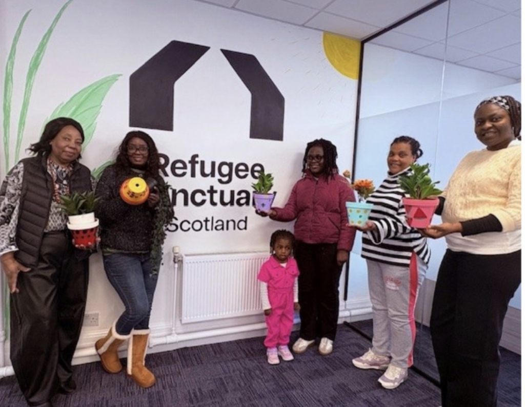 group of people at new office space for refugee sanctuary scotland